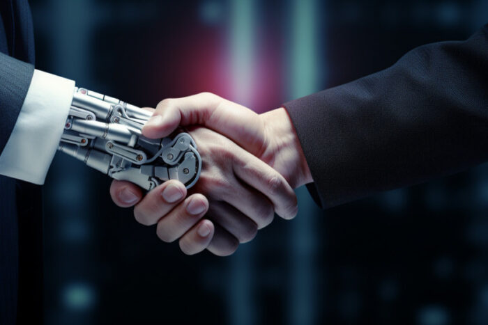 Robot estrecha la mano a un ejecutivo.